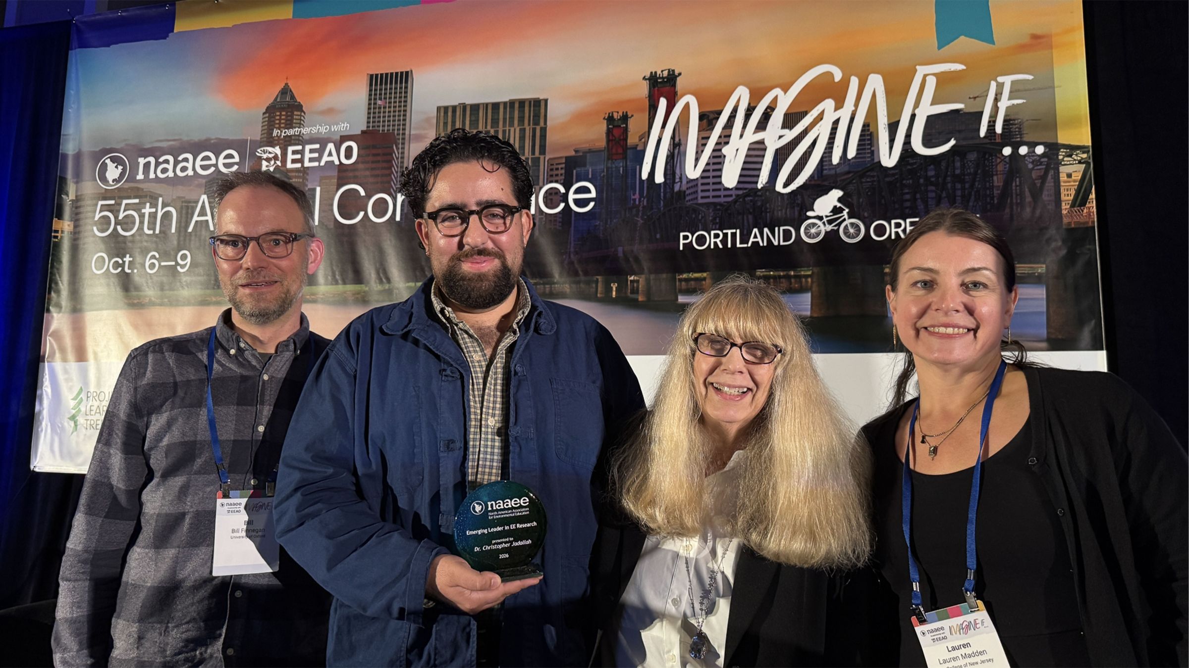 Christopher accepts his award at NAAEE 2026.