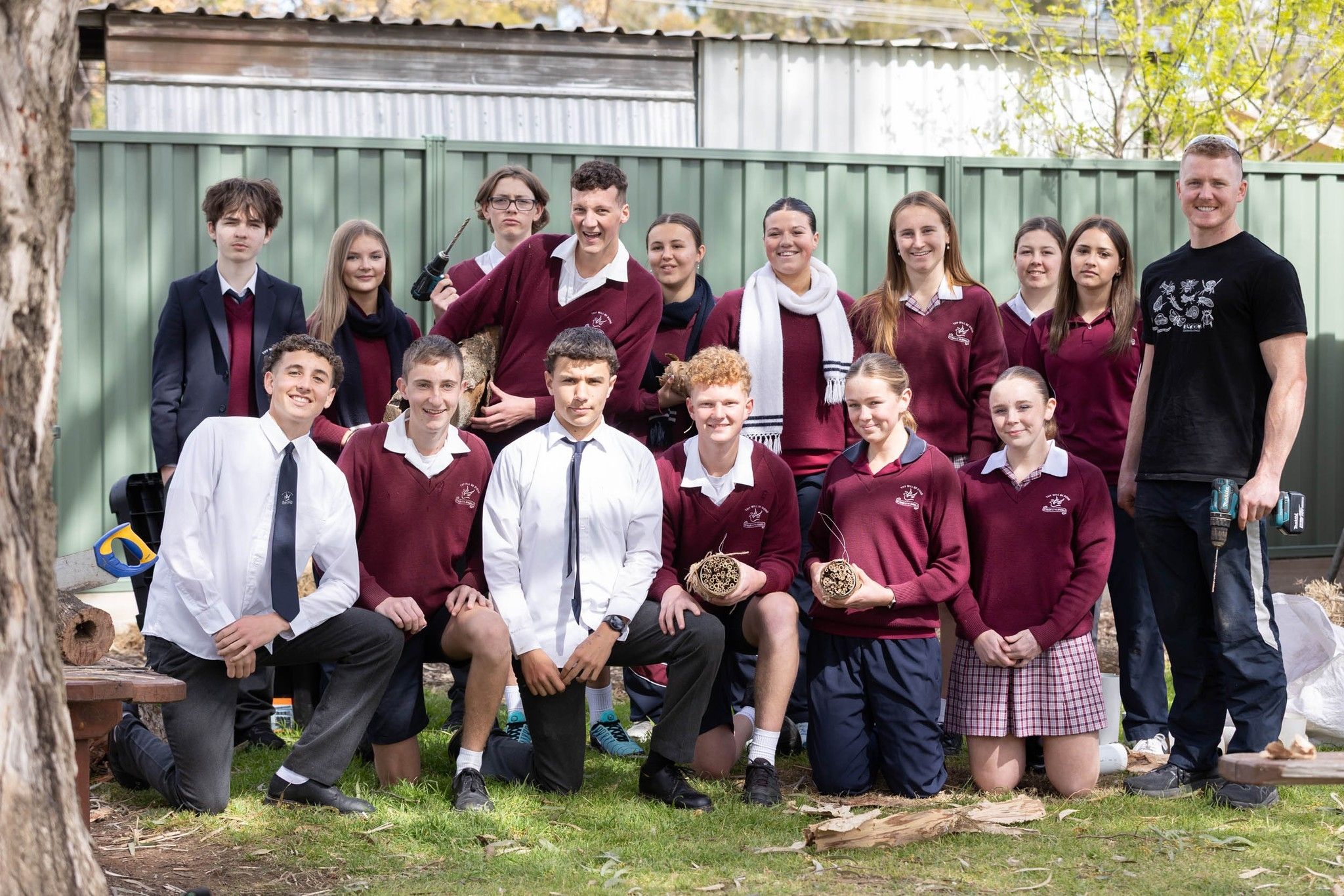 Clancy and a large group of students pose for a photo