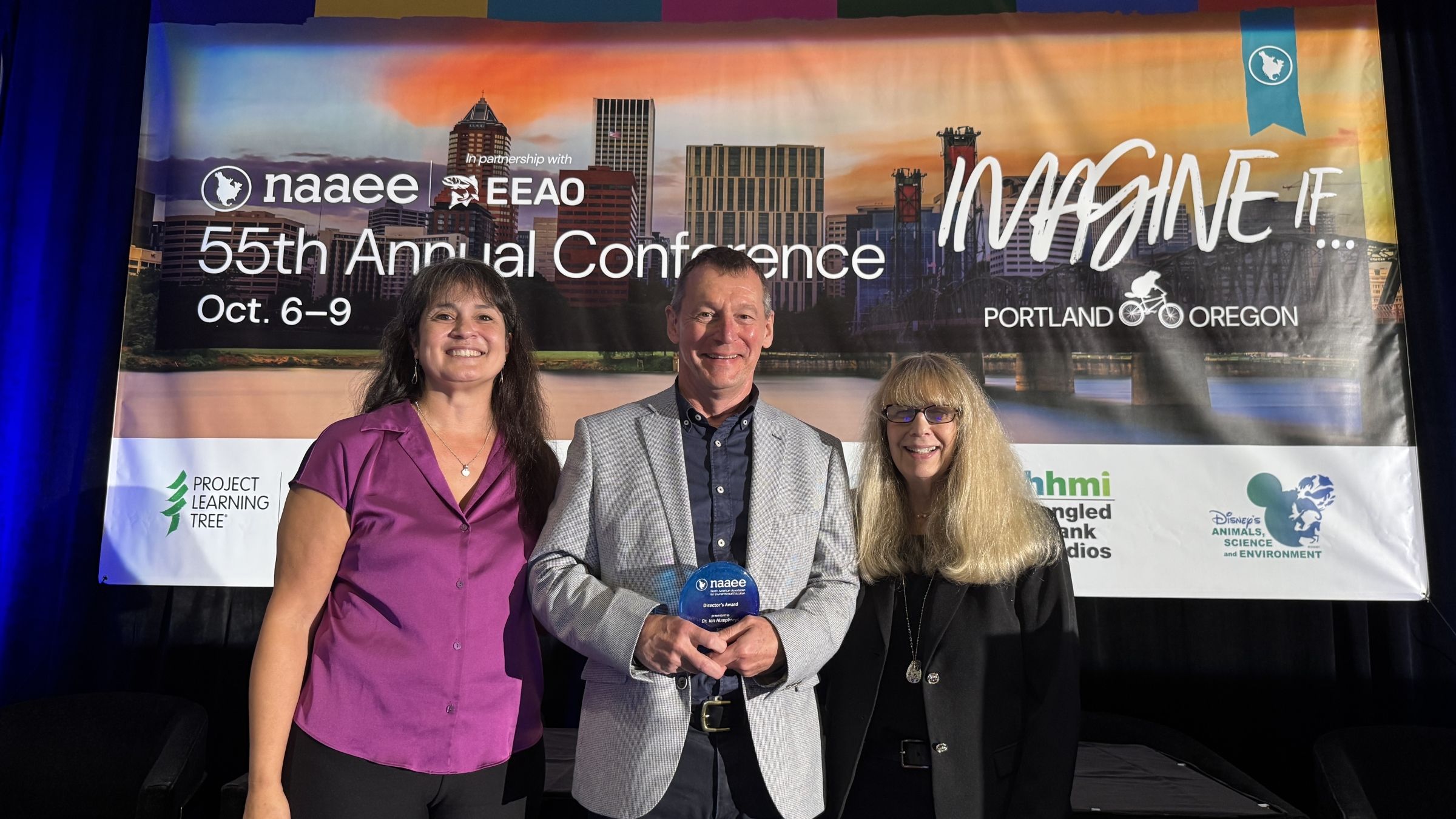 Ian accepts his award at NAAEE 2026.