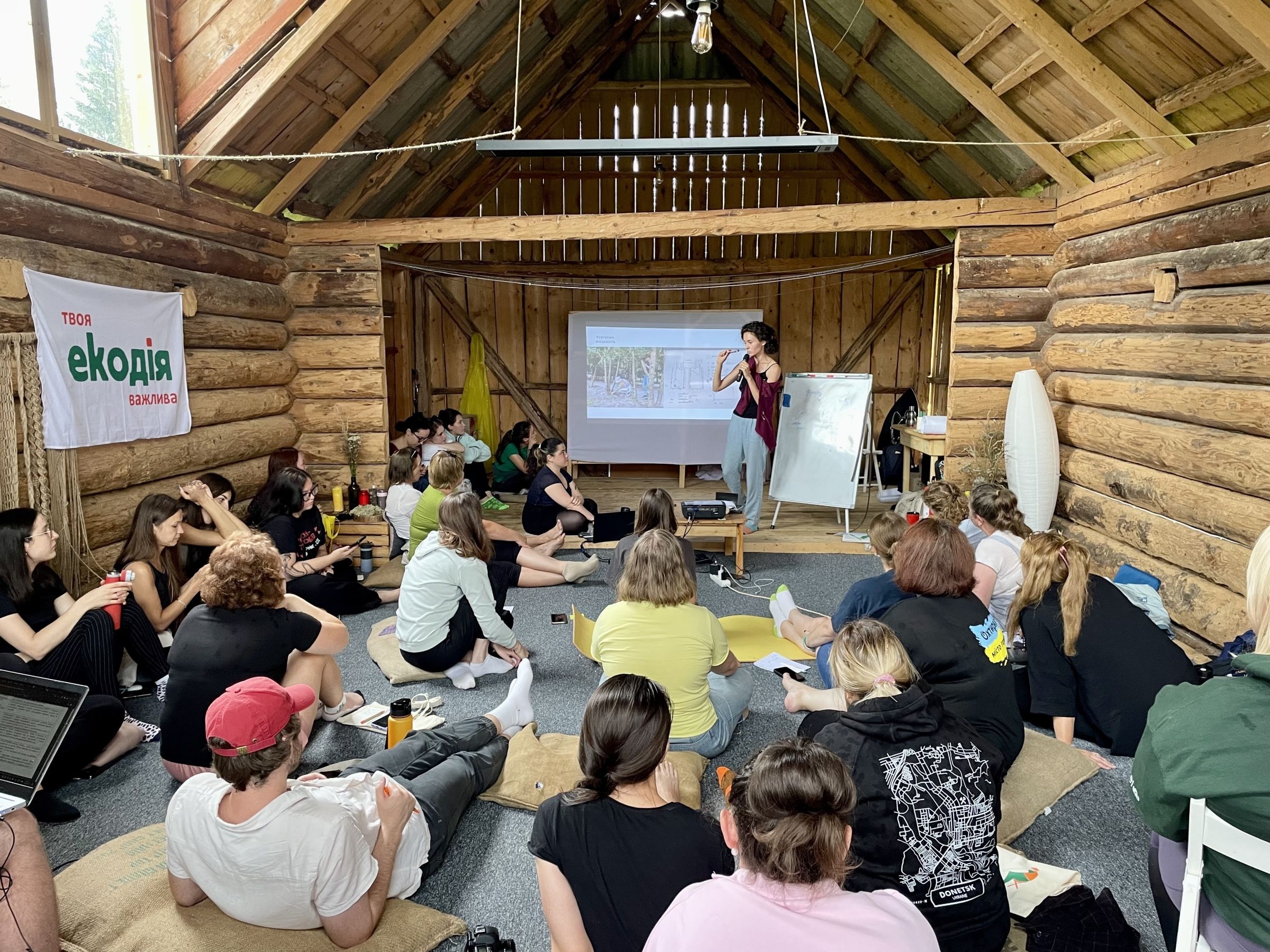 A group of people listening to a speaker