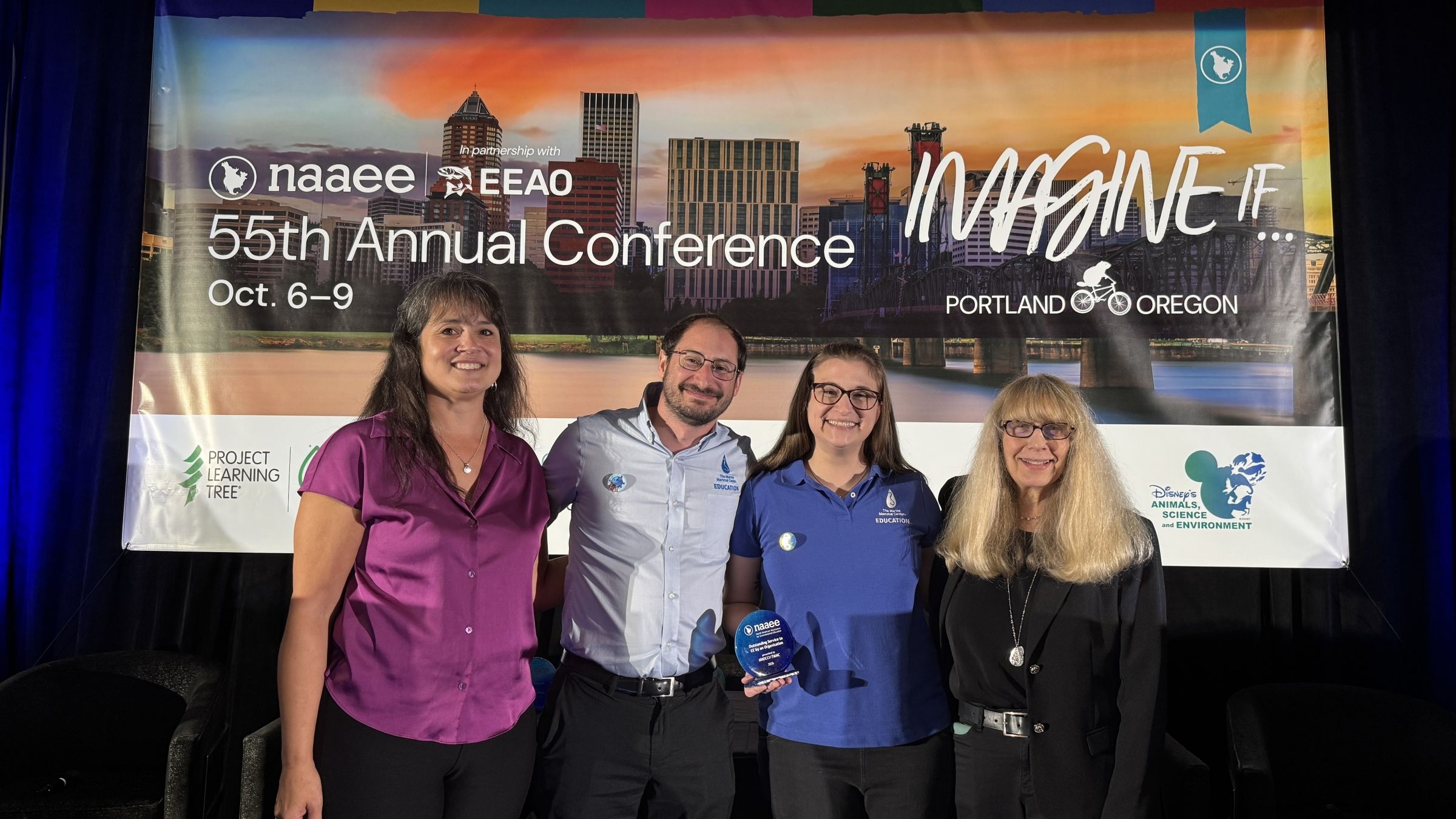 The Marine Mammal Center and NNOCCI accept their award at NAAEE 2026.