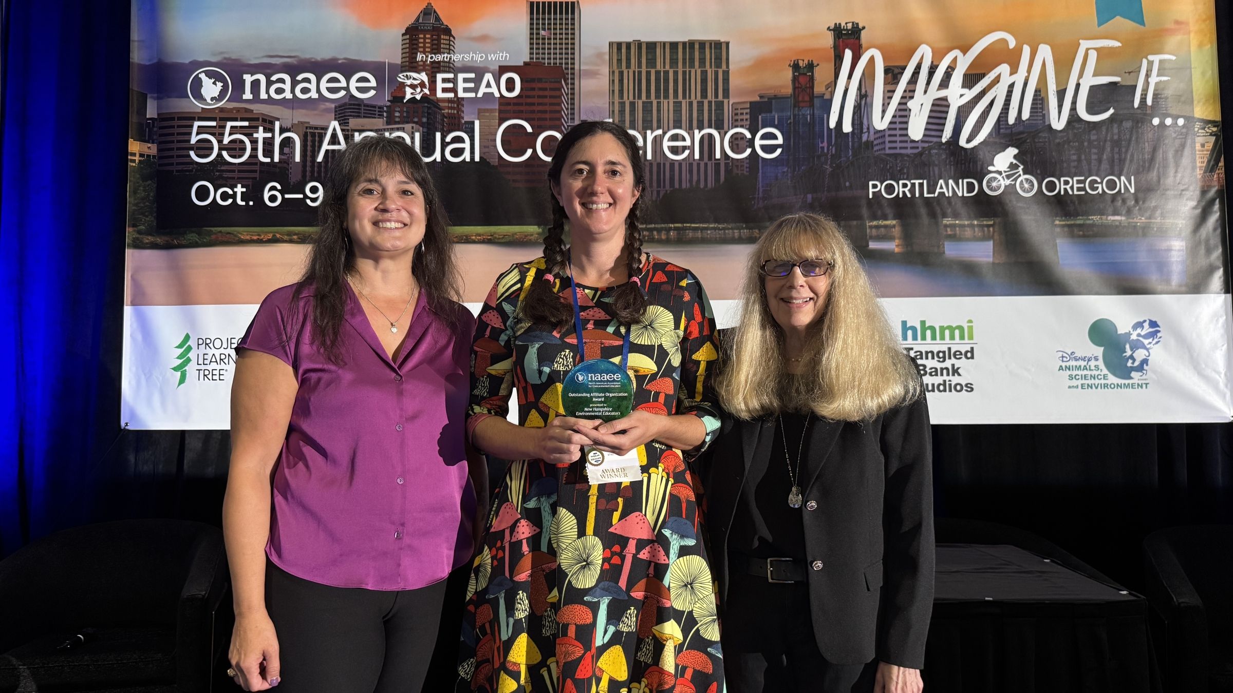 NHEE accepts their award at NAAEE 2026.