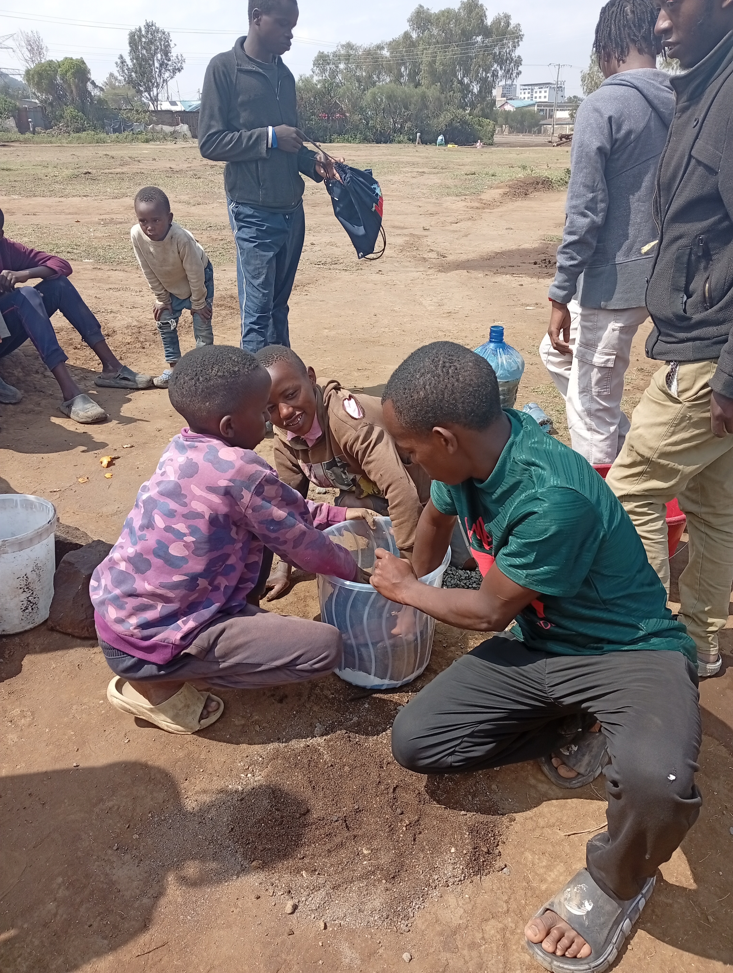 Students work together to prepare a planter