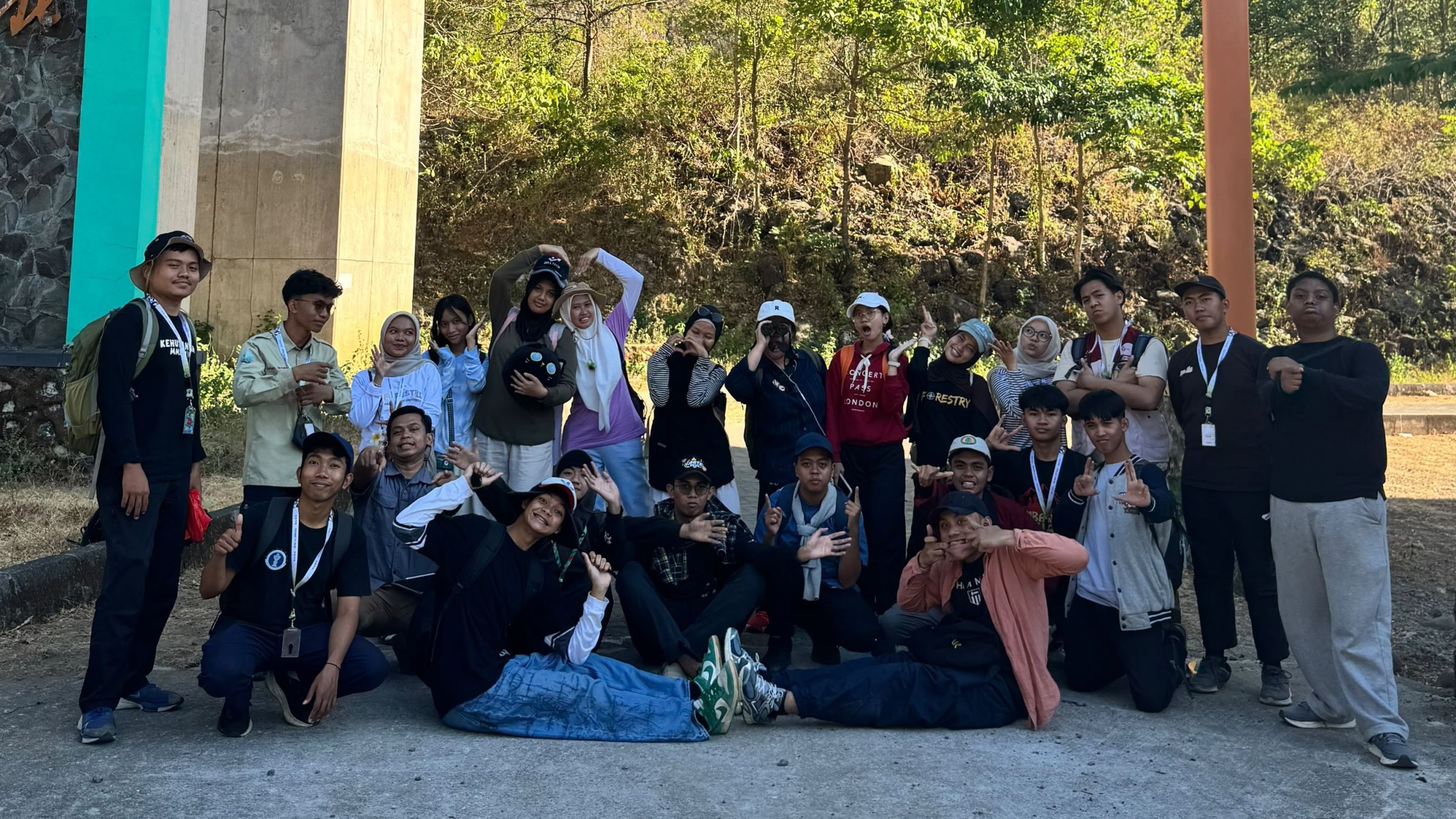A group of young people pose for a photo in nature