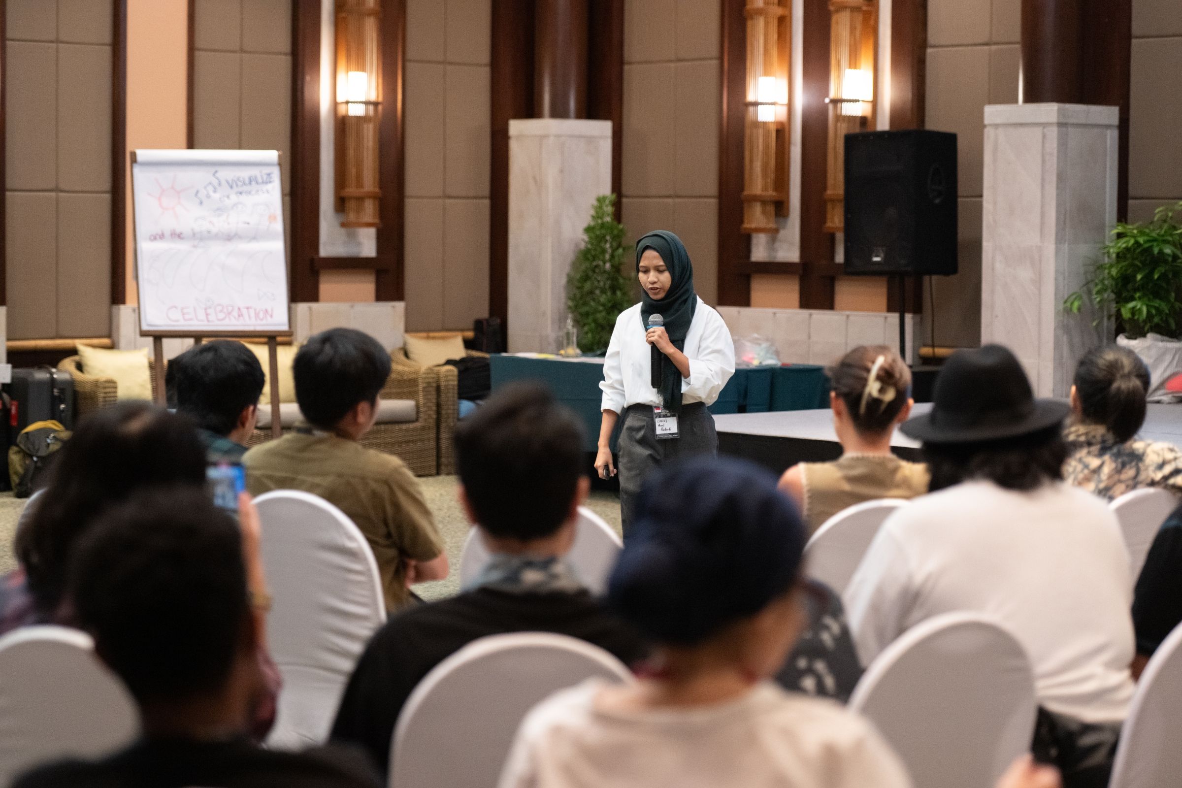 Lulu presents in front of a group of people