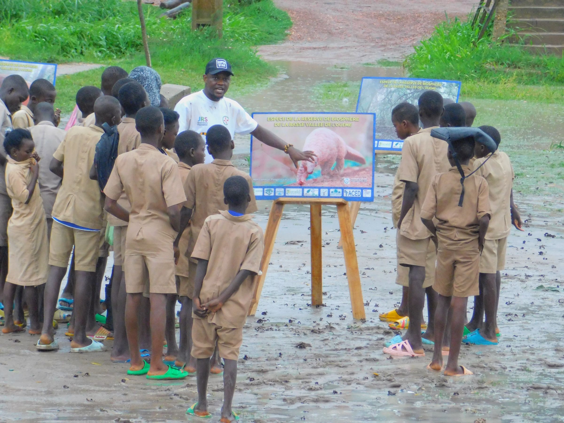 Philemon teaching a group of students in nature