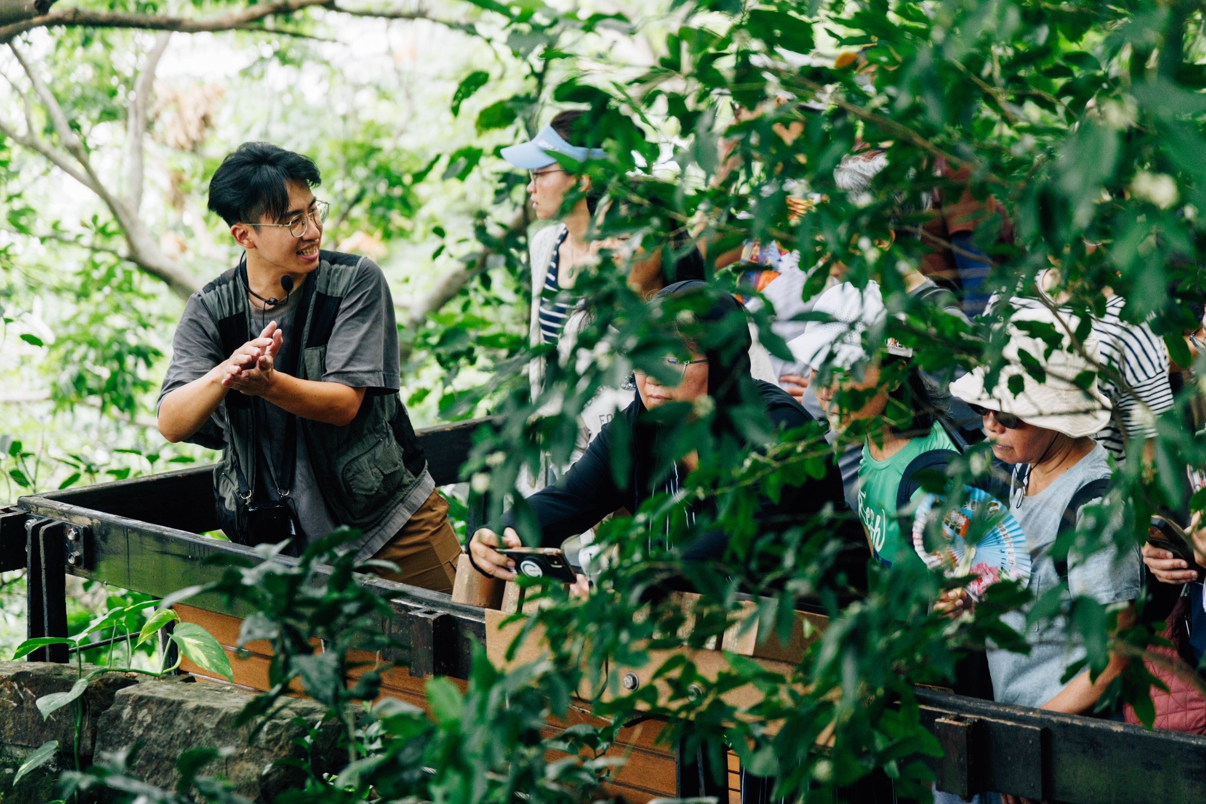 Yan-Da talking to a small group of people in a nature park